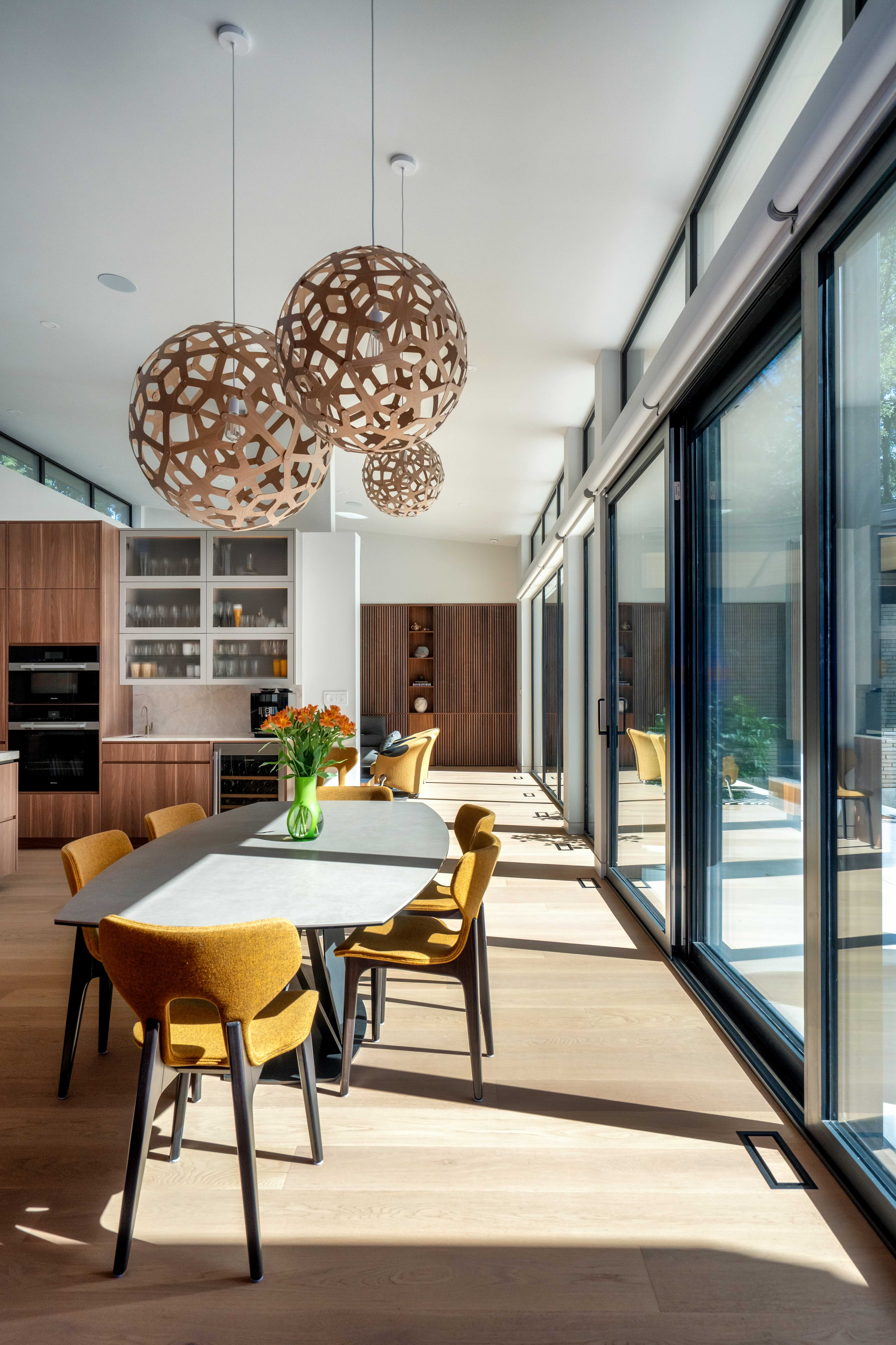 Dining space with sculptural pendant lights